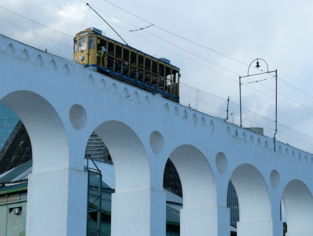 a train traveling over a bridge with arches