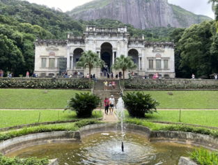 a large building with a fountain in front of it